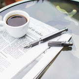 TWSBI Precision Fountain pen and cup of coffee on an open book