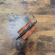 Fisher Space Pen Shuttle Pen matte black with chrome trim on pen stand