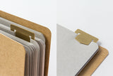 TRAVELER's Company Brass Template Bookmarks Shown Clipped To notebook