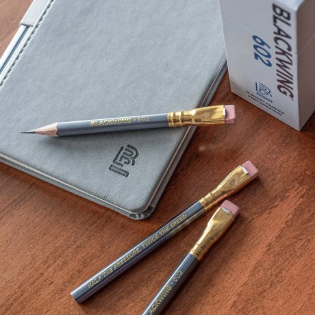 Blackwing 602 Short Pencil on desk with notebook