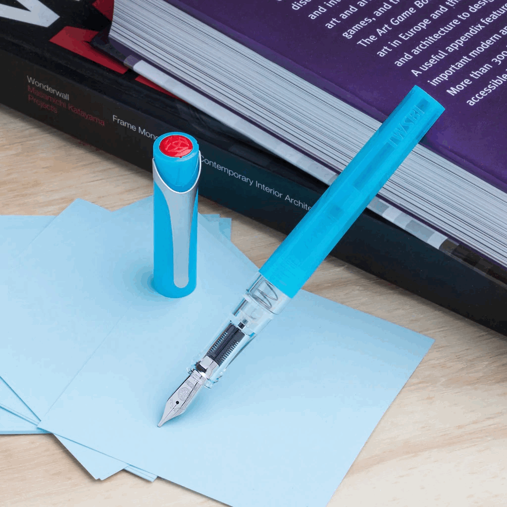 Ice Blue TWSBI Swipe Fountain Pen Uncapped resting on book