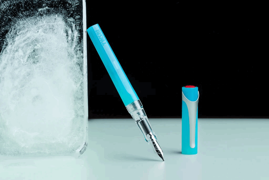 Ice Blue TWSBI Swipe Fountain Pen Uncapped resting against a block of ice