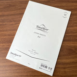 Package of blank loose leaf Tomoe River A4 paper on a table.
