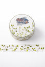 Washi sample and roll with a design of curvy stems with round green dots like leaves on a light background, created with fountain pen ink.